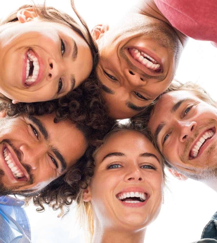 Smiling person showcasing white teeth after laser whitening treatment Plymouth